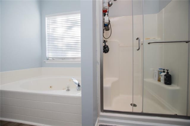 bathroom featuring independent shower and bath