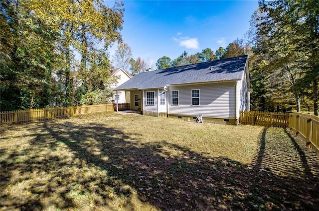 rear view of house featuring a lawn