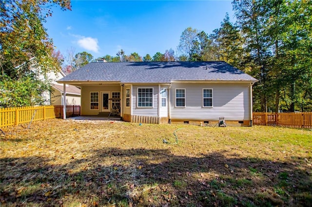 back of house featuring a patio area and a lawn