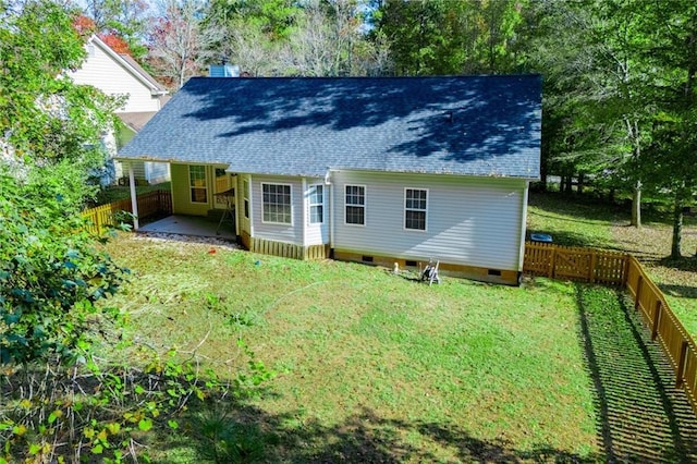 rear view of property featuring a yard and a patio