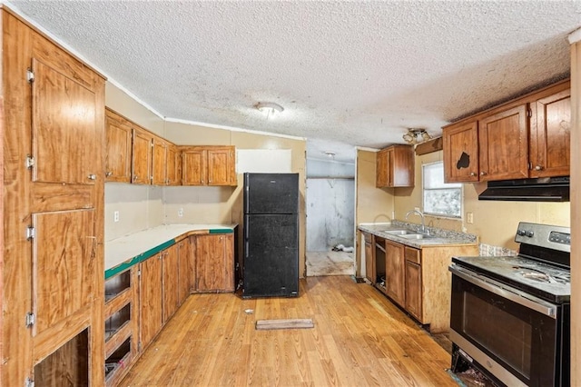 kitchen with sink, light wood-type flooring, a textured ceiling, and black appliances