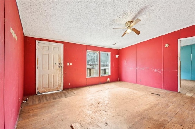 interior space featuring a textured ceiling, ceiling fan, and light hardwood / wood-style flooring