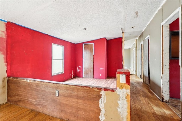 empty room featuring dark hardwood / wood-style floors and a textured ceiling