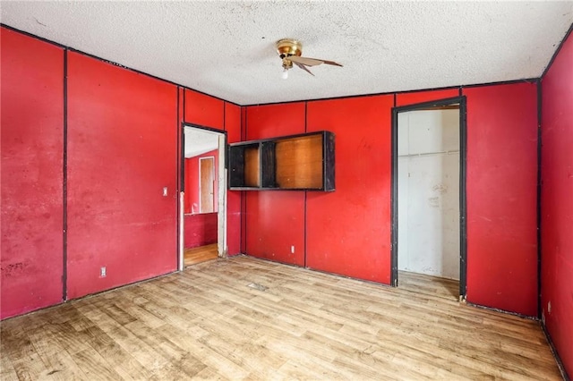 unfurnished bedroom featuring a textured ceiling and light wood-type flooring