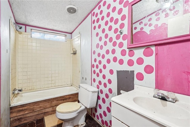 full bathroom with vanity, toilet, tiled shower / bath combo, and a textured ceiling