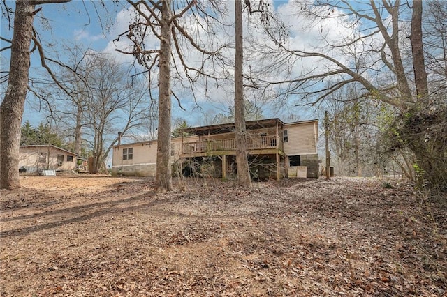 rear view of house featuring a deck