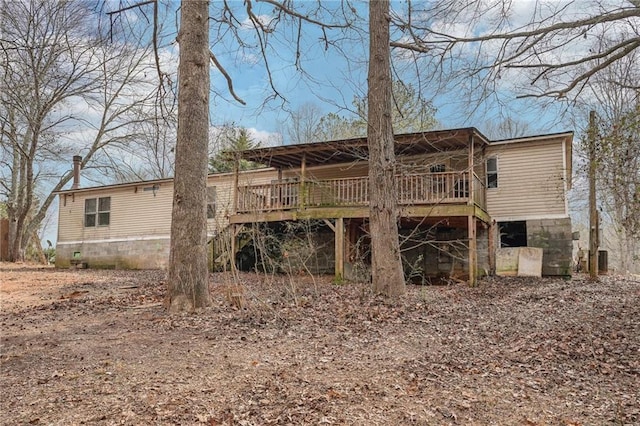 rear view of property with a wooden deck