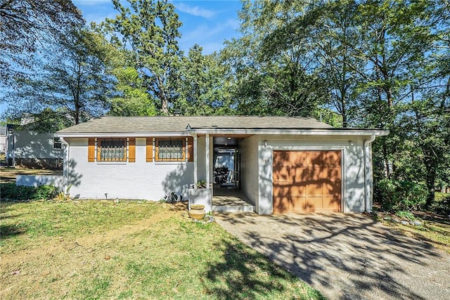 ranch-style house with a garage, aphalt driveway, a front lawn, and brick siding