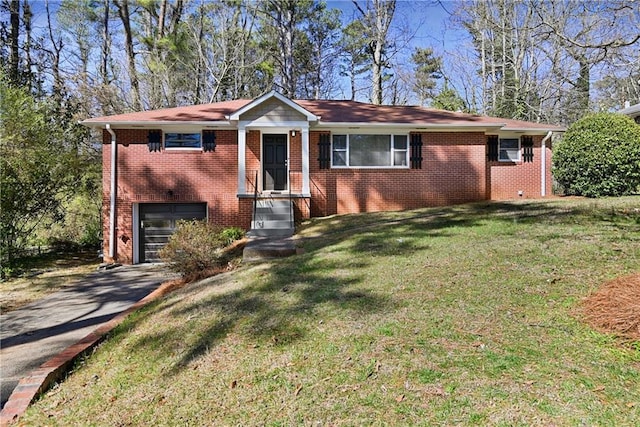 view of front of house with a front yard, brick siding, and driveway