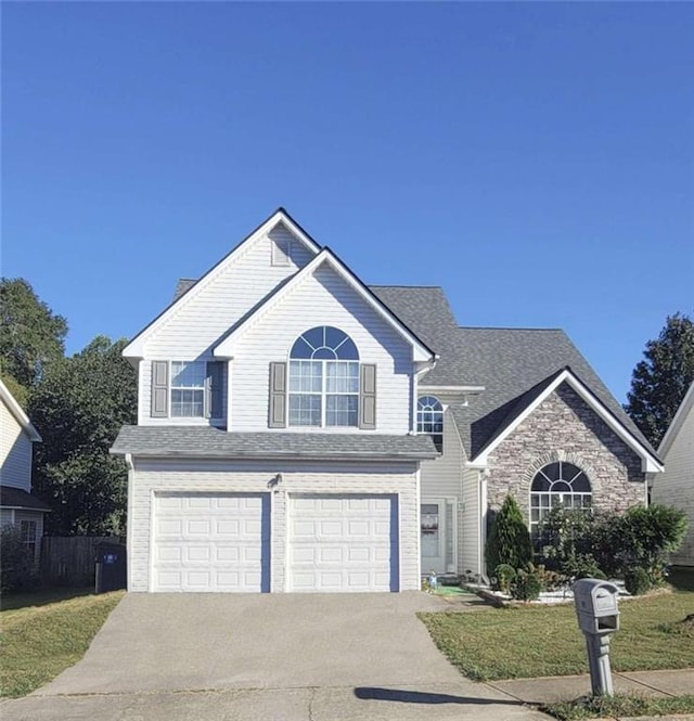 view of property with a front yard and a garage