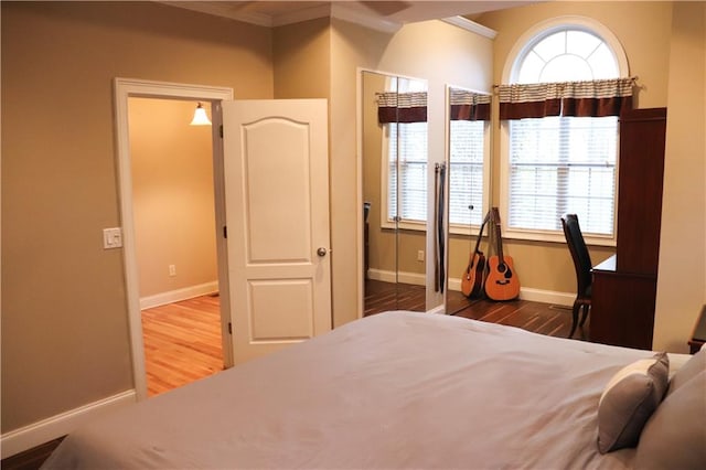 bedroom with hardwood / wood-style floors and crown molding