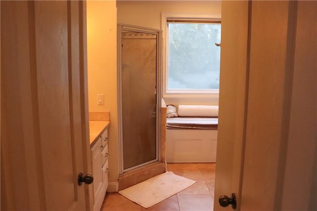 bathroom featuring tile patterned floors, vanity, and walk in shower