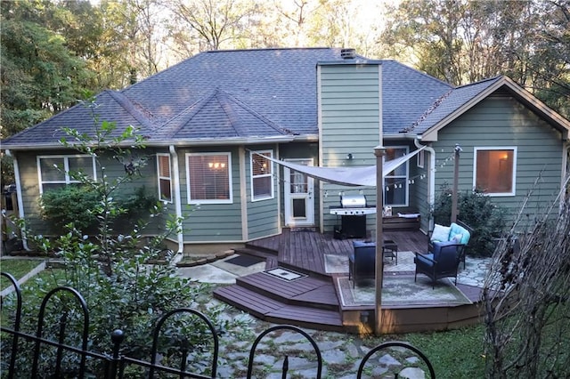 back of house featuring a wooden deck