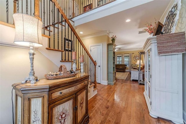 foyer with hardwood / wood-style floors and ornamental molding