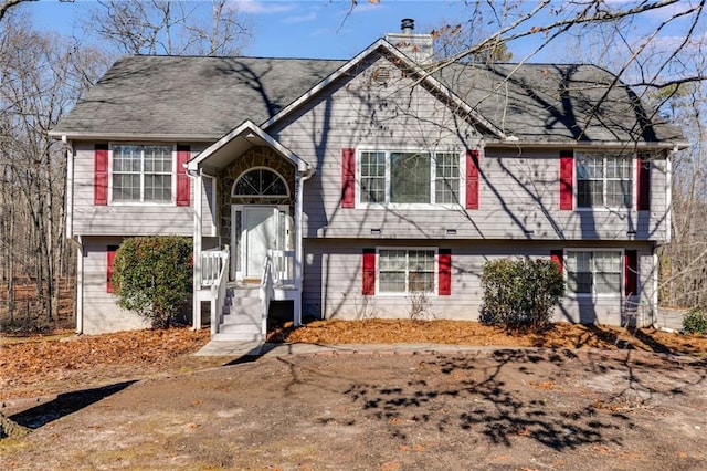 split foyer home featuring a chimney