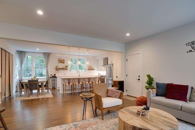 living room featuring light wood-type flooring and sink