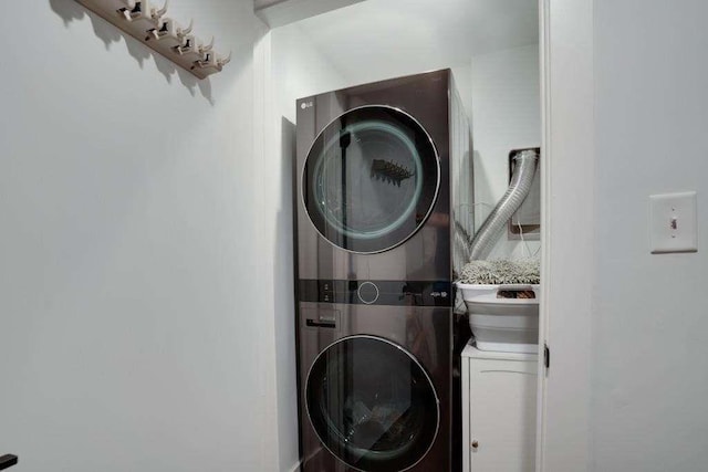 laundry area with stacked washer and dryer