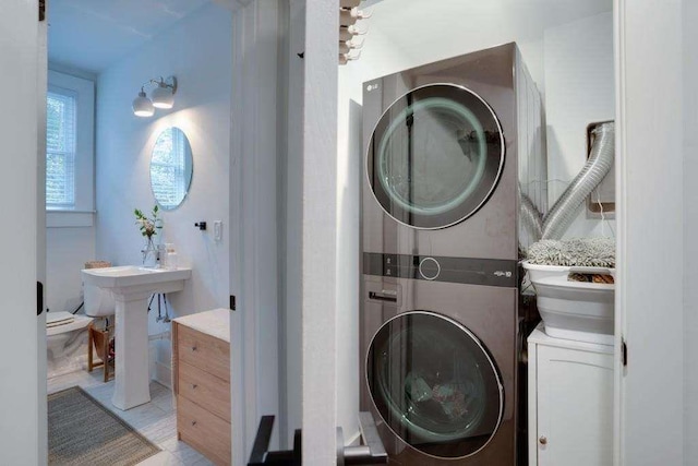 laundry room with stacked washer / dryer