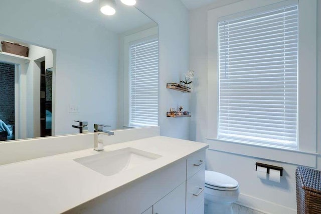 bathroom featuring vanity and toilet