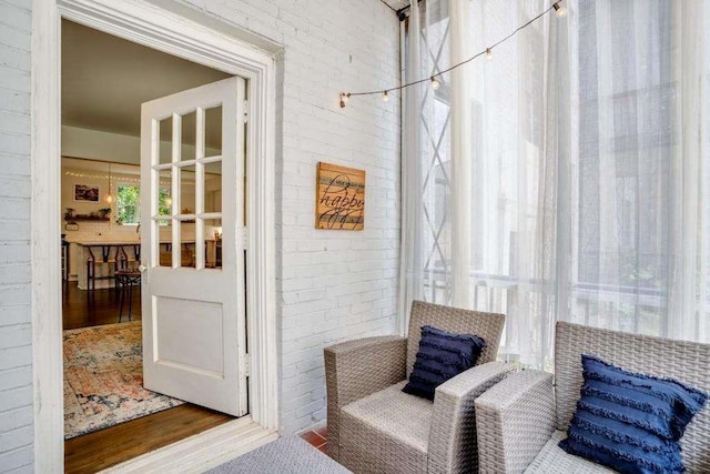 living area with brick wall