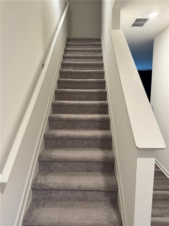 536 Magnolia Cir Unit 116, Palmetto, GA 30268 - staircase featuring wood finished floors and baseboards