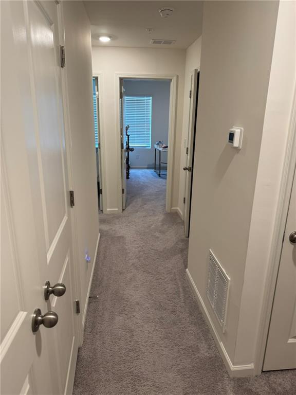 536 Magnolia Cir Unit 116, Palmetto, GA 30268 - hallway with carpet floors and baseboards