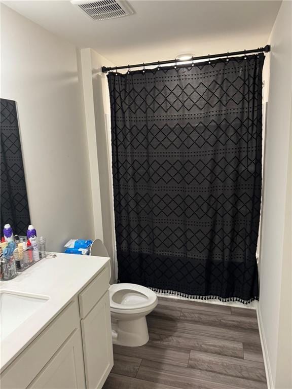 536 Magnolia Cir Unit 116, Palmetto, GA 30268 - bathroom with vanity, toilet, wood finished floors, and tiled shower