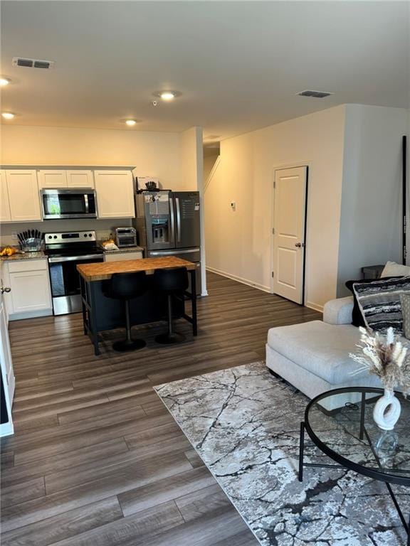 536 Magnolia Cir Unit 116, Palmetto, GA 30268 - living area with dark wood-style floors, recessed lighting, and baseboards