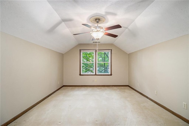 bonus room with light carpet, baseboards, ceiling fan, lofted ceiling, and a textured ceiling
