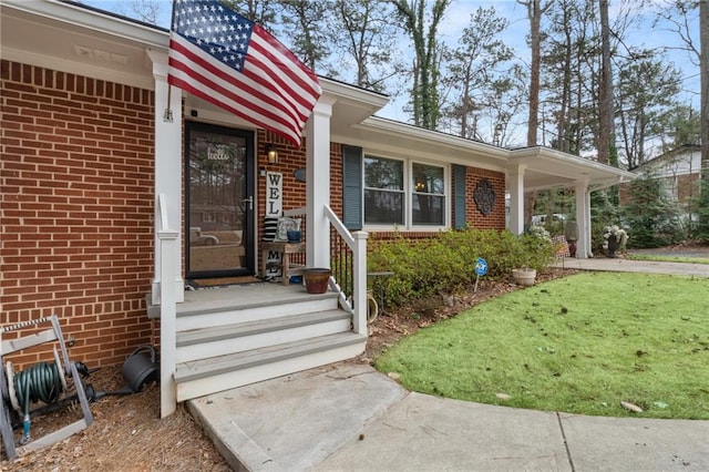 view of exterior entry with brick siding