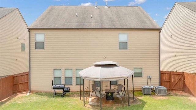 556 Emporia Loop, Mcdonough, GA 30253 - rear view of house with a gazebo, central AC unit, and a patio area