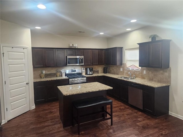 556 Emporia Loop, Mcdonough, GA 30253 - kitchen with stainless steel appliances, a kitchen island, backsplash, light stone counters, and recessed lighting