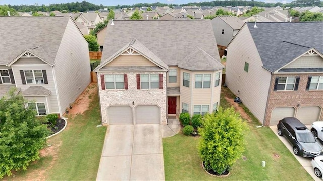 556 Emporia Loop, Mcdonough, GA 30253 - view of front of house with an attached garage, concrete driveway, a residential view, and a front yard