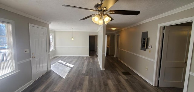 foyer entrance featuring dark wood-style flooring, crown molding, a textured ceiling, and baseboards