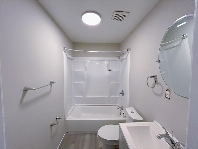 full bath featuring visible vents, toilet, wood finished floors, bathtub / shower combination, and vanity