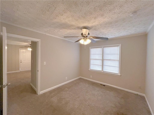 unfurnished room featuring baseboards, a ceiling fan, ornamental molding, a textured ceiling, and carpet flooring