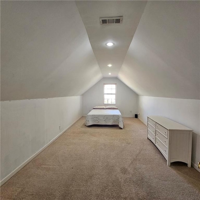 unfurnished bedroom with light carpet and lofted ceiling