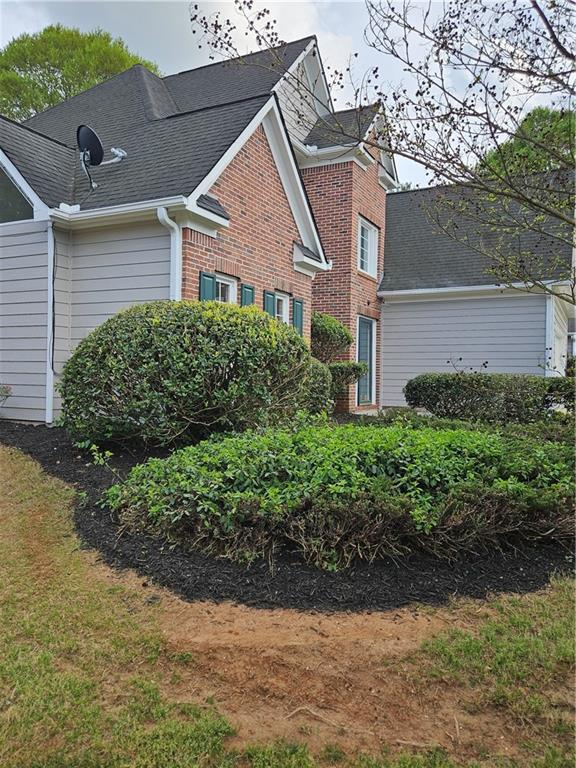 view of side of home featuring brick siding