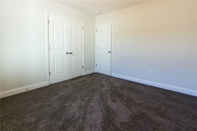 40 Eryn Ter, Covington, GA 30014 - unfurnished bedroom with dark colored carpet and a closet