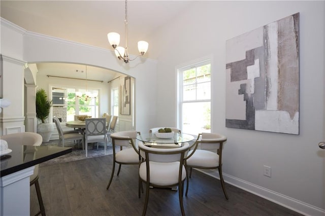 40 Eryn Ter, Covington, GA 30014 - dining area with a chandelier, arched walkways, and dark wood finished floors