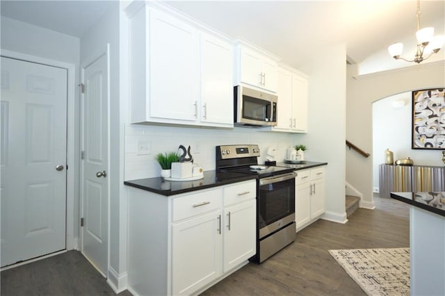 40 Eryn Ter, Covington, GA 30014 - kitchen featuring stainless steel appliances, dark countertops, and dark wood-style flooring