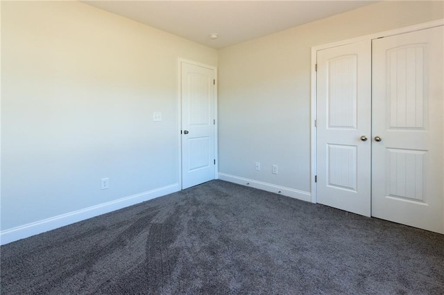 40 Eryn Ter, Covington, GA 30014 - unfurnished bedroom with dark colored carpet and a closet