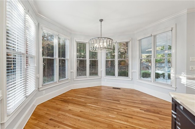 unfurnished sunroom with plenty of natural light and an inviting chandelier