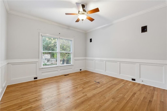 spare room with ceiling fan, ornamental molding, and hardwood / wood-style flooring