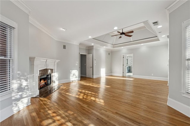 unfurnished living room with crown molding, a fireplace, ceiling fan, and wood-type flooring