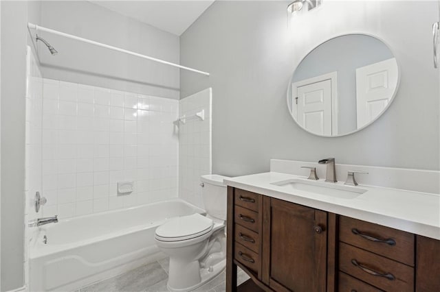 full bathroom featuring tile patterned floors, vanity, tiled shower / bath combo, and toilet