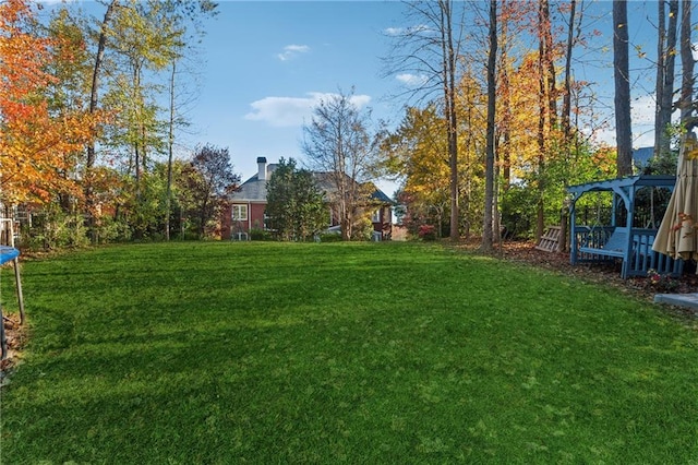 view of yard with a gazebo and a trampoline