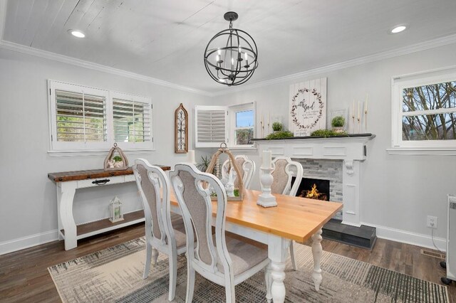 dining room with crown molding, baseboards, and a wealth of natural light