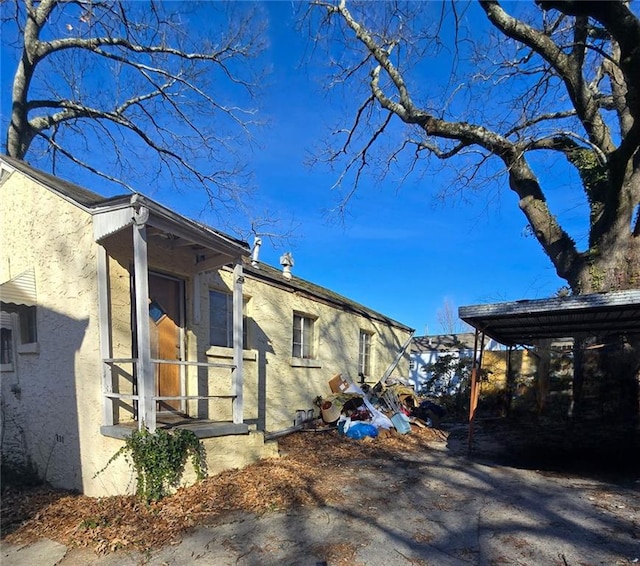 view of side of home featuring a carport