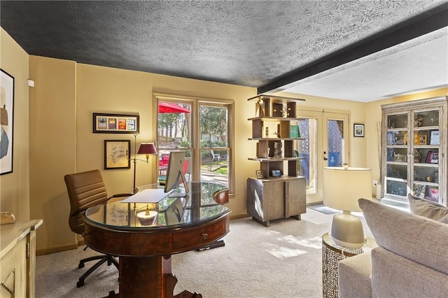 office featuring beam ceiling, carpet flooring, and a textured ceiling